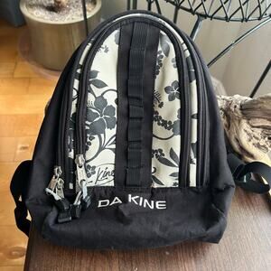 Dakine Cosmo 6.5L backpack with a black and white floral patter